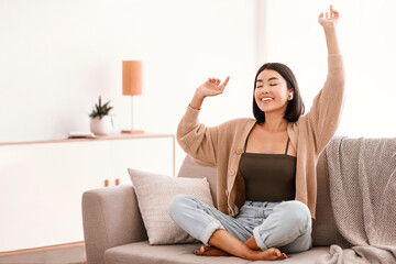 Leisure Concept. Portrait of overjoyed asian woman wearing wireless earbuds, listening to her...