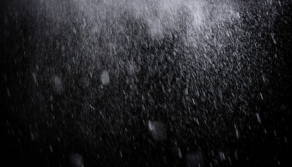 the texture of rain and fog on a black background creates a dramatic overlay effect with abstract splashes of rain and snow particles in freeze motion