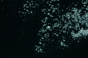 Many water bubbles on black background, closeup. Space for text