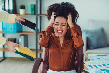 Stressed businesswoman overwhelmed with tasks in modern office workspace, expression of frustration...
