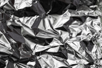 Texture of crumpled aluminium foil as background, closeup
