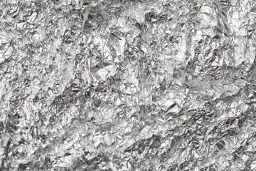 Texture of crumpled aluminium foil as background, closeup