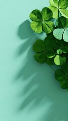 Green clover leaves on mint textured background representing luck and st patricks day
