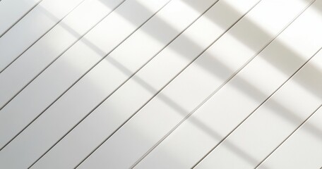 White wall with diagonal shadows.  Clean, bright, and simple lines.  Sunlight casts patterns