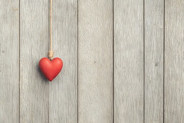 Hanging Heart: A simple red heart hangs against a weathered wooden backdrop, symbolizing love, affection, and the simplicity of connection.