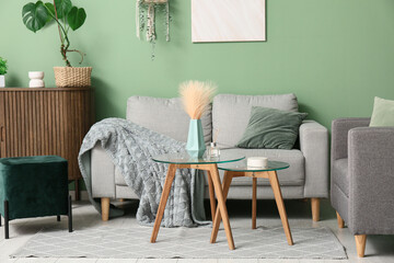 Interior of living room with sofa, armchair and tables