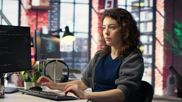 IT female technician uses coding language on computer at the agency, creating software to work on implementing algorithms. IT expert building applications with a programming interface. Camera B.