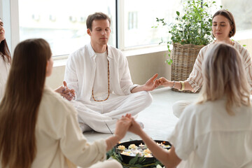 Group of people meditating in circle
