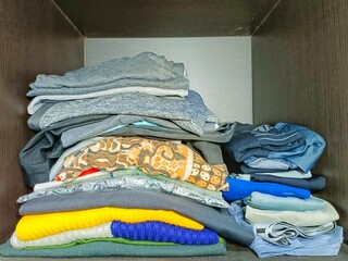 Stacked Clothing in Wardrobe Organizing Clean Clothes