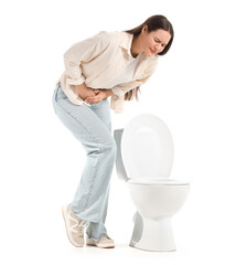 Young woman near toilet bowl on white background. Cystitis concept