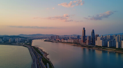 Obraz premium Incheon city skyline along river at sunset.