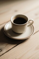 there is a cup of coffee on a saucer on a wooden table