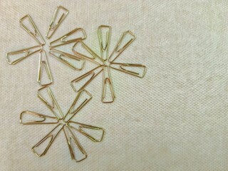 Arrangement of Paper Clips Forming Floral Shapes on Textured Surface