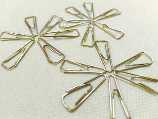 Fototapeta premium Paper Clips Arranged in Floral Patterns on Fabric