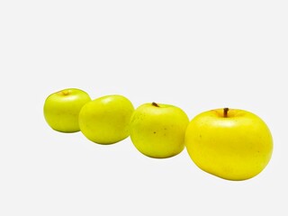Golden Apples Lined Up on White Background Closeup