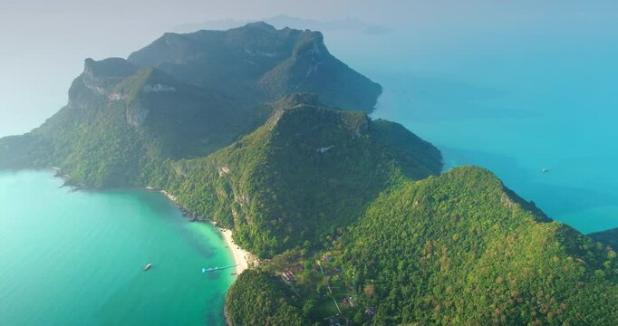 Aerial drone footage of Moo Koh Ang Thong National Marine Park showing turquoise water and green rainforest covering islands in Gulf of Thailand, Southeast Asia during a sunny summer day