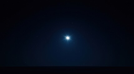 A bright star shines in the dark night sky, surrounded by smaller stars above a faint horizon.