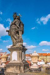 Fototapeta premium Statue of St. Anthony of Padua with baby Jesus near Old Town Bridge Tower. The sandstone statue was created by Jan Oldřich Mayer in 1707. Prague, 2020