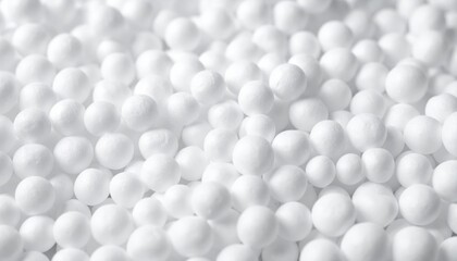 A close-up view of numerous small, white, spherical objects creating a textured, uniform surface