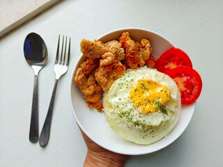 Serving of Rice, Fried Chicken, Egg, and Tomato Slices in Bowl