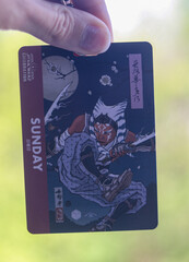 Naklejka premium Tokyo, Japan - May 8, 2025 - Caucasian hand holding an entry badge for Sunday for the Star Wars Celebration 2025 featuring an artwork of the character Ahsoka Tano