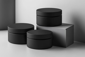Black round plastic cosmetic jar mockup, three boxes stacked on a grey background with soft shadows. 