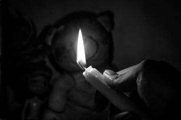 hand holding a burning candle, Candles burning in the dark