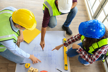 Architects and engineer team woman and man working on solar panel and blueprints with Solar...