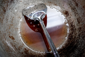 Top view of used oil remaining in a kitchen frying pan