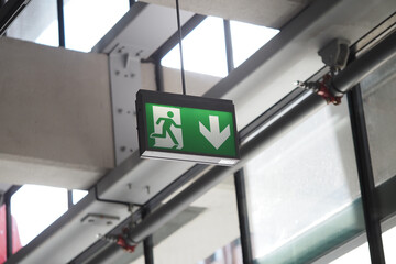 Emergency exit sign displayed inside a modern building