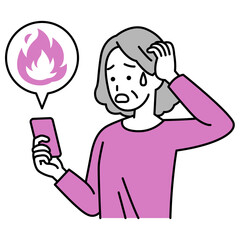 SNSが炎上して困惑している年配の女性（スマートフォン）