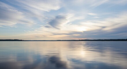 Fototapeta premium Peaceful Sunset over Calm Water with Colorful Sky Reflection