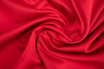 Full frame shot of wrinkled red polyester cloth texture and background.