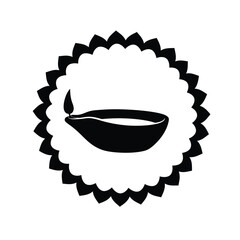 Simple black and white diya oil lamp inside decorative scalloped circle design