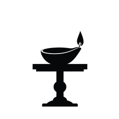 Black and white illustration of a lit diya lamp on a decorative table