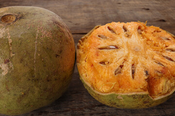 Southeast Asa wood apple bael fruit Limonia acidissima hard shell half inside flesh made juice drink ingredients