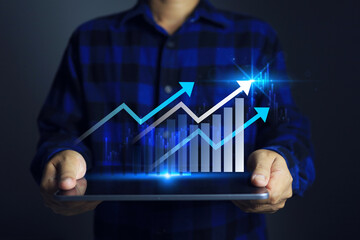 The upward graph on the tablet indicates that the business has achieved its goal of profit and will continue to plan for the next fiscal year to differentiate itself from competitors