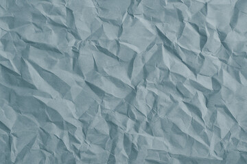 Obraz premium Crumpled Faded Blue Paper Texture Background – Realistic Wrinkled Soft Blue Surface for Collage, Scrapbook, or Design Use