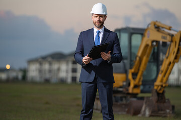 Construction manager in suit and helmet at a construction site. Construction manager worker or...