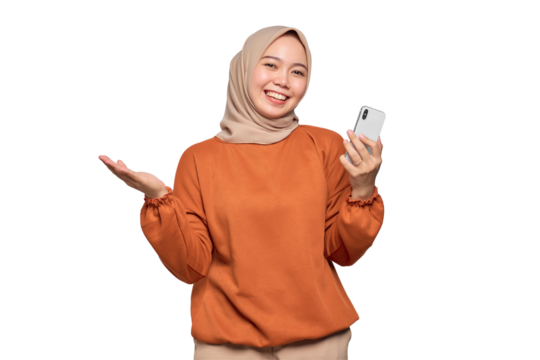 Cheerful young Asian woman in orange shirt using mobile phone reading news from social network isolated on transparent background