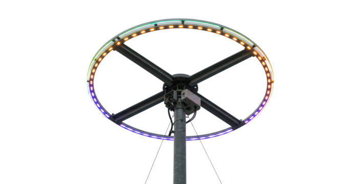 Isolated photo of a black metal carnival or fairground ride mechanism with colorful LED lights