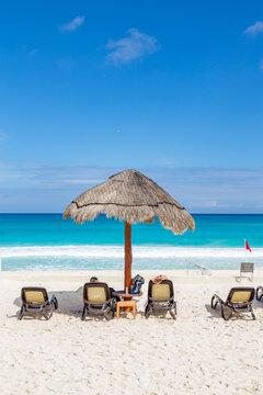 Sandy beach with chairs and umbrella, Cancun, Mexico