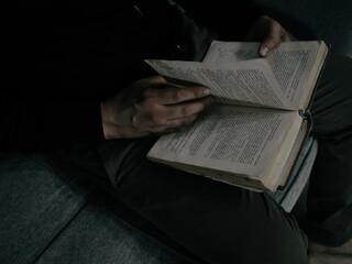 An adult man reading a book