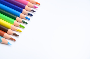 Close-up of colorful pencils arranged diagonally on white isolated background. Perfect for school ads, creativity, and educational design use.