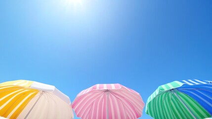 Colorful striped umbrellas under sunny summer sky beach vacation theme