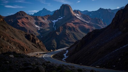 AI-generated winding road through a rugged mountain landscape under a clear blue sky