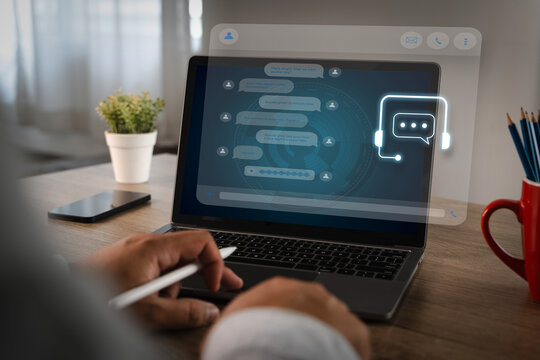 Businessman using AI chatbot interface on laptop for digital contact center support