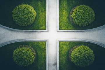 Aerial view of garden with round bushes and cross shaped path in formal design from above