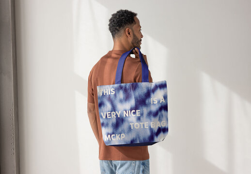 Anonymous Man holding Tote Bag. PSD template ready for Mockup