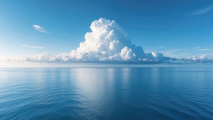 Obraz premium Blue sky featuring a prominent white cloud above tranquil sea landscape and horizon, perfect for summer travel scenes